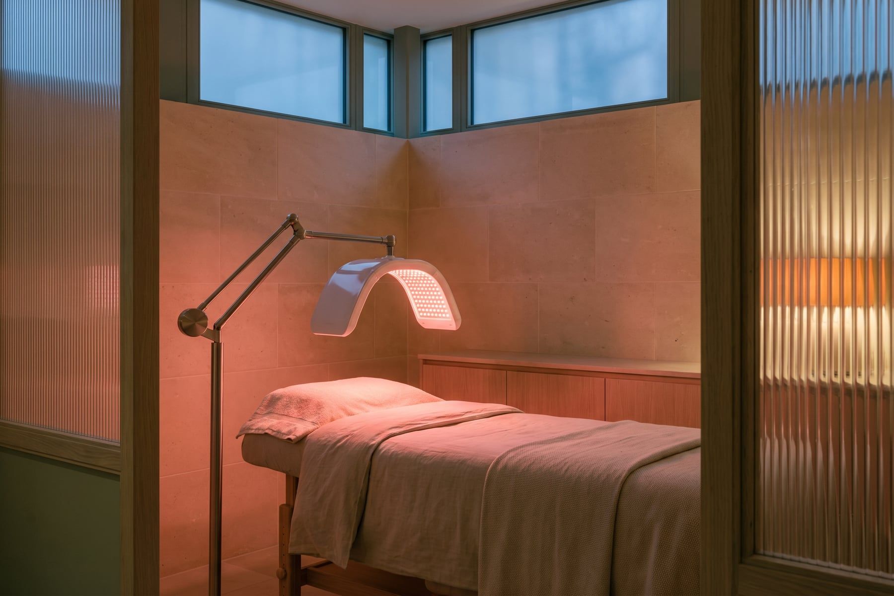 A dim room with a curved LED panel glowing soft red